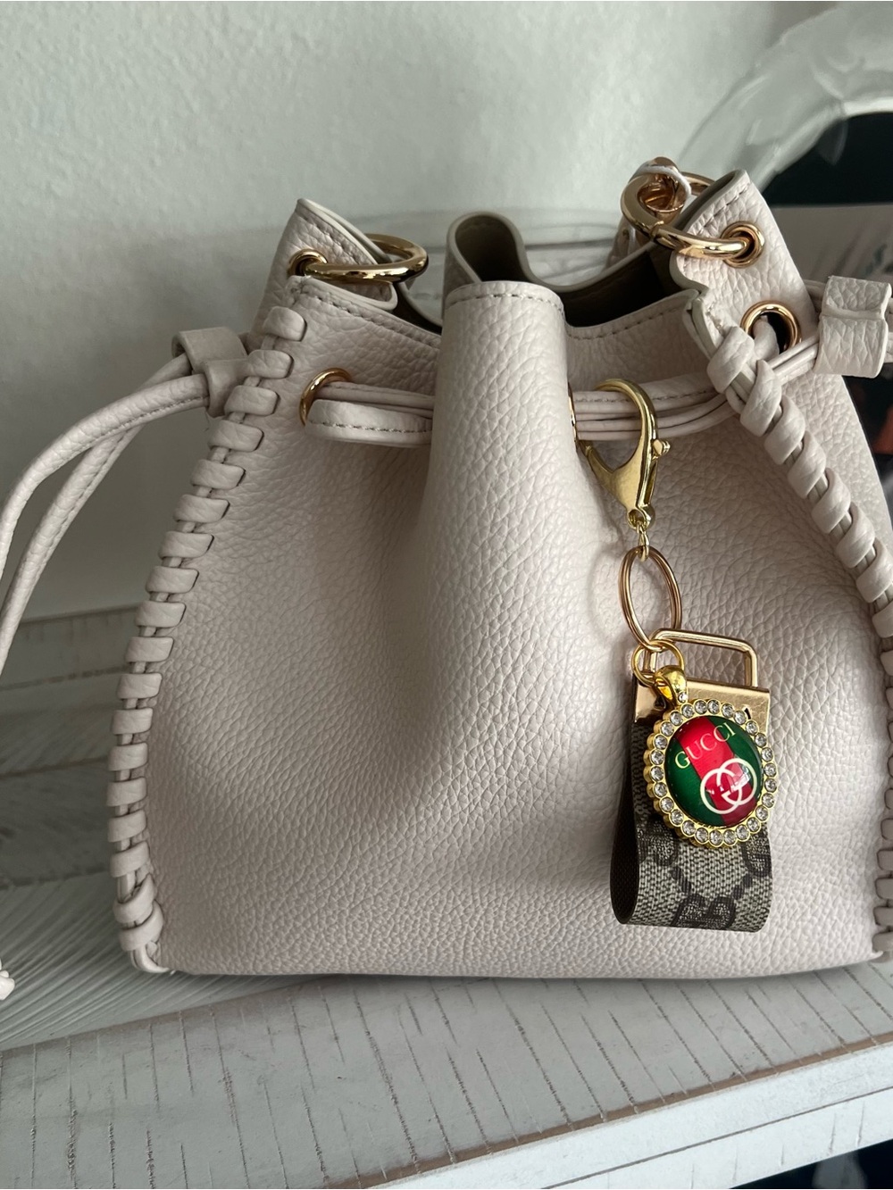 Two piece Ivory Pebbled Leather Drawstring Shoulder Bag with Gold Charm